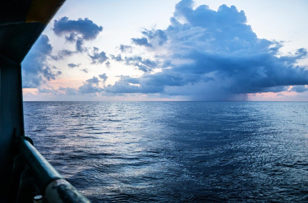 Sunset sea the sun is covered with clouds open